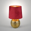Lampa stołowa z abażurem czerwono-złota zaświecona, widoczna od przodu.