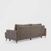 Sofa FORESTER z brązową tapicerką, ustawiona na jasnym tle, widziana z tyłu pod kątem.