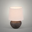 Lampa stołowa z abażurem beżowa zaświecona widoczna od przodu.