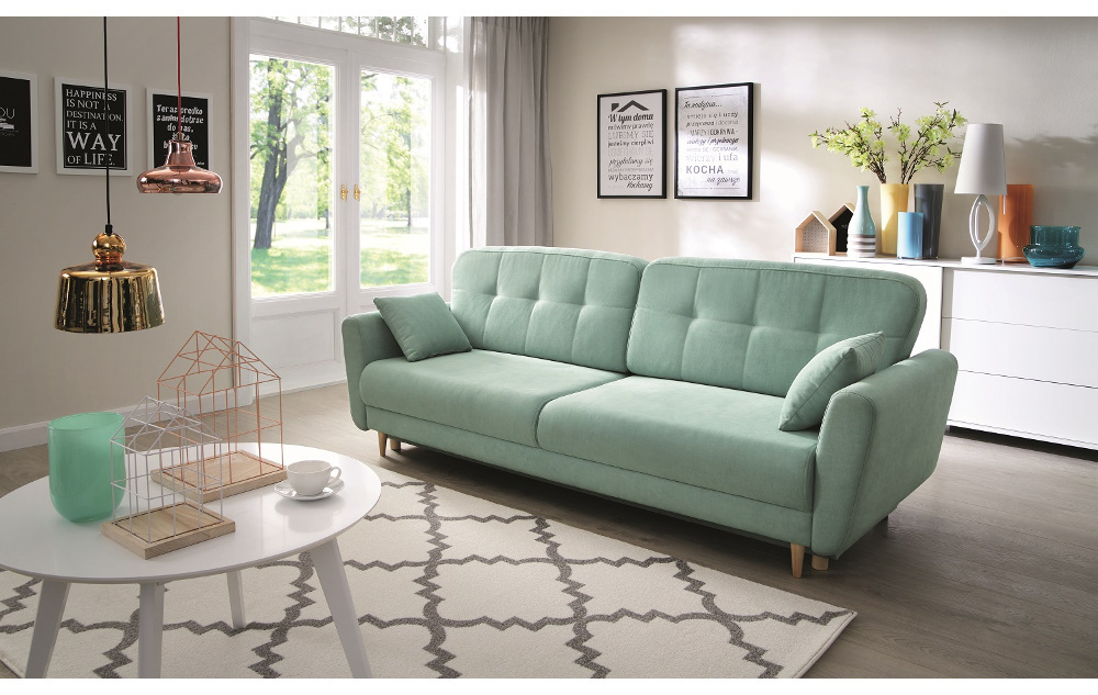 Miętowa sofa do salonu z pikowanym oparciem i drewnianymi nóżkami w eleganckiej aranżacji wnętrza.